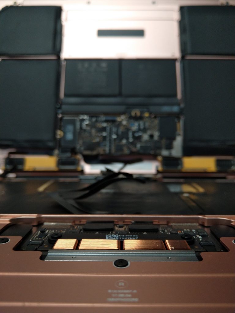 MacBook internals open on the repair bench