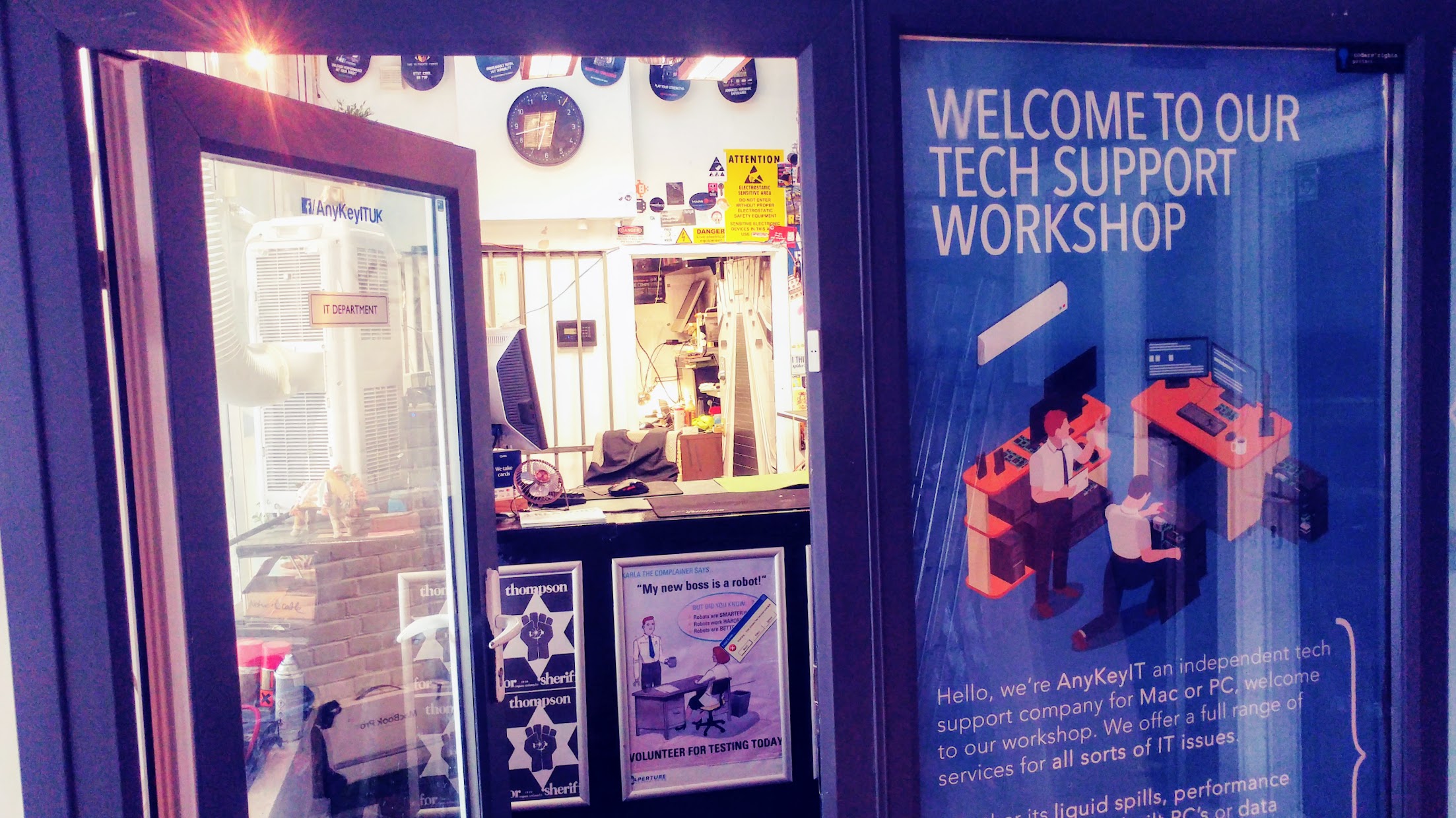 The AnyKey IT workshop window in Hackney Wick, sign reading 'Welcome to our tech support workshop'